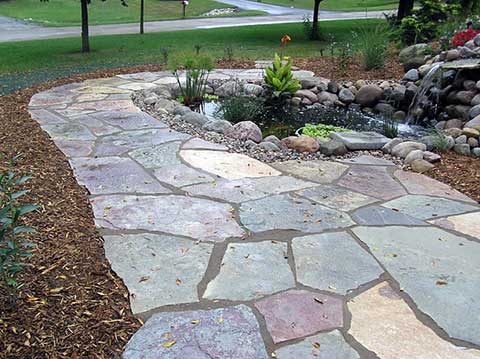 flagstone walkway encircling a pond